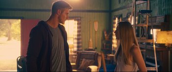Movie still from “The Final Girls” (2015), directed by Todd Strauss-Schulson – A man and a woman standing next to each other in a room; Medium shot, Over the shoulder angle