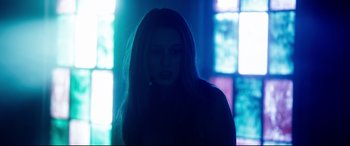 Movie still from “The Final Girls” (2015), directed by Todd Strauss-Schulson – A woman with long hair standing in front of a window; Medium shot, Low angle