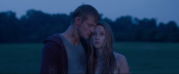 Movie still from “The Final Girls” (2015), directed by Todd Strauss-Schulson – A man and a woman standing next to each other in a field; Close Up shot, Over the shoulder angle