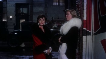 Movie still from “The Five Pennies” (1959), directed by Melville Shavelson – Two women standing next to each other on the sidewalk; Medium shot, Low angle