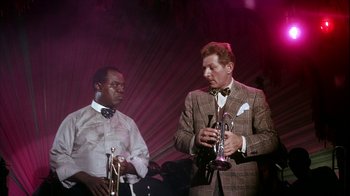 Movie still from “The Five Pennies” (1959), directed by Melville Shavelson – Two men in suits and bow ties are holding trumpets; Medium shot, Low angle