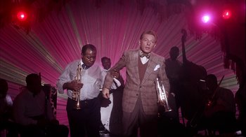 Movie still from “The Five Pennies” (1959), directed by Melville Shavelson – A man in a suit and bow tie holding a trumpet; Medium shot, High angle