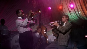 Movie still from “The Five Pennies” (1959), directed by Melville Shavelson – A group of men playing musical instruments on a stage; Medium shot, Low angle