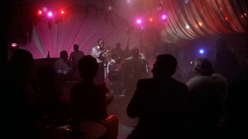 Movie still from “The Five Pennies” (1959), directed by Melville Shavelson – A group of people in a room with lights; Wide shot, Over the shoulder angle