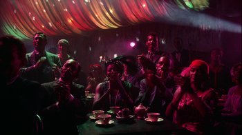 Movie still from “The Five Pennies” (1959), directed by Melville Shavelson – A group of people sitting at a table in a room; Wide shot, High angle
