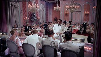 Movie still from “The Five Pennies” (1959), directed by Melville Shavelson – A group of people sitting at tables in formal wear; Wide shot, High angle