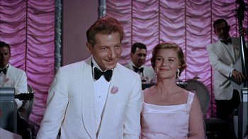 Movie still from “The Five Pennies” (1959), directed by Melville Shavelson – A man and a woman standing next to each other; Medium shot, Low angle