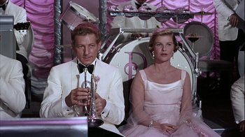 Movie still from “The Five Pennies” (1959), directed by Melville Shavelson – A man and a woman sitting next to each other; Medium shot, High angle