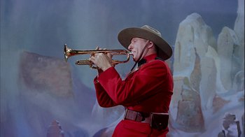Movie still from “The Five Pennies” (1959), directed by Melville Shavelson – A man in a cowboy hat playing a trumpet; Medium shot, Low angle