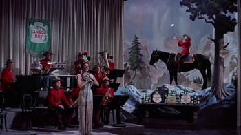 Movie still from “The Five Pennies” (1959), directed by Melville Shavelson – A group of people dressed in red are playing music; Wide shot, Low angle