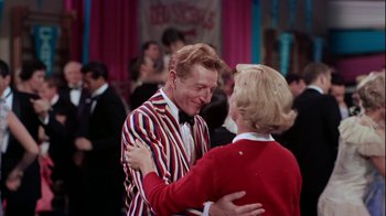 Movie still from “The Five Pennies” (1959), directed by Melville Shavelson – A man and a woman dancing together at a party; Medium shot, Over the shoulder angle