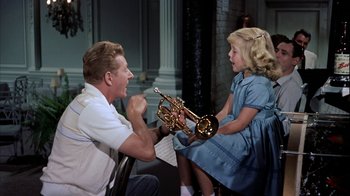 Movie still from “The Five Pennies” (1959), directed by Melville Shavelson – A man and a little girl are playing the trumpet; Medium shot, High angle