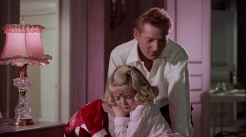 Movie still from “The Five Pennies” (1959), directed by Melville Shavelson – A man and a little girl sitting next to each other; Medium shot, Low angle