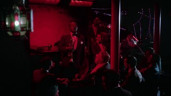 Movie still from “The Five Pennies” (1959), directed by Melville Shavelson – A group of people sitting around a room; Wide shot, High angle