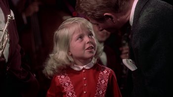 Movie still from “The Five Pennies” (1959), directed by Melville Shavelson – A young girl in a red dress is looking at a man in a black suit; Close Up shot, Over the shoulder angle