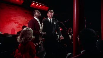 Movie still from “The Five Pennies” (1959), directed by Melville Shavelson – A man in a black suit and a woman in a white dress; Medium shot, High angle