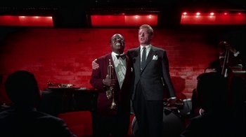 Movie still from “The Five Pennies” (1959), directed by Melville Shavelson – Two men standing next to each other on a stage; Medium shot, Low angle