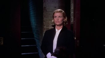 Movie still from “The Five Pennies” (1959), directed by Melville Shavelson – A woman standing in front of a brick wall; Medium shot, Low angle