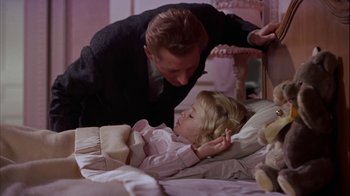 Movie still from “The Five Pennies” (1959), directed by Melville Shavelson – A man and a little girl laying in a bed; Medium shot, High angle