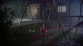 Movie still from “The Five Pennies” (1959), directed by Melville Shavelson – A little girl sitting on a swing in the middle of the night; Extreme Wide shot, High angle