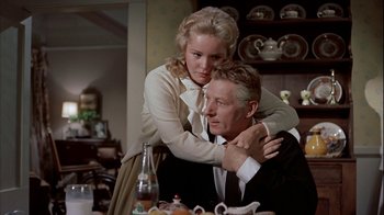 Movie still from “The Five Pennies” (1959), directed by Melville Shavelson – A man and a woman sitting at a dinner table; Medium shot, Low angle