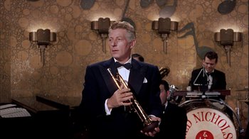 Movie still from “The Five Pennies” (1959), directed by Melville Shavelson – A man in a tuxedo holding a trumpet; Medium shot, Low angle
