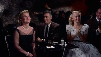 Movie still from “The Five Pennies” (1959), directed by Melville Shavelson – A group of people sitting around a table; Medium shot, Low angle