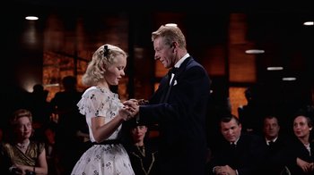 Movie still from “The Five Pennies” (1959), directed by Melville Shavelson – A man and a woman are holding hands and smiling; Medium shot, Low angle