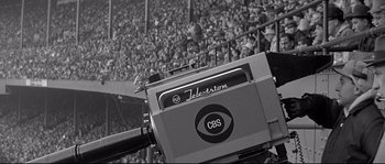 Movie still from “The Fortune Cookie” (1966), directed by Billy Wilder – An old television in front of a crowd of people; Medium shot, High angle