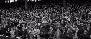 Movie still from “The Fortune Cookie” (1966), directed by Billy Wilder – A large group of people sitting in a stadium; Wide shot, High angle