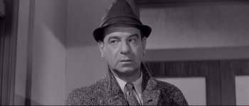 Movie still from “The Fortune Cookie” (1966), directed by Billy Wilder – An older man wearing a hat and a jacket; Close Up shot, Over the shoulder angle