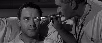 Movie still from “The Fortune Cookie” (1966), directed by Billy Wilder – A man is being examined by another man; Close Up shot, Over the shoulder angle