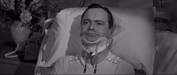 Movie still from “The Fortune Cookie” (1966), directed by Billy Wilder – A black and white photo of a man in a neck brace; Close Up shot, Low angle