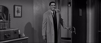 Movie still from “The Fortune Cookie” (1966), directed by Billy Wilder – Black and white photograph of a man in a suit; Medium shot, Over the shoulder angle