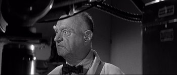 Movie still from “The Fortune Cookie” (1966), directed by Billy Wilder – An older man wearing a bow tie and ear cuff; Close Up shot, Low angle