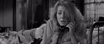 Movie still from “The Fortune Cookie” (1966), directed by Billy Wilder – A woman sitting on a couch talking on a phone; Close Up shot, Over the shoulder angle