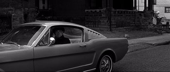 Movie still from “The Fortune Cookie” (1966), directed by Billy Wilder – A man sitting in the driver's seat of a car; Medium shot, High angle