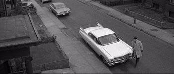 Movie still from “The Fortune Cookie” (1966), directed by Billy Wilder – A couple of cars parked on the side of a road; Extreme Wide shot, High angle