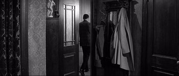 Movie still from “The Fortune Cookie” (1966), directed by Billy Wilder – A black and white photo of a man in a suit and tie; Wide shot, Over the shoulder angle