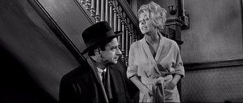 Movie still from “The Fortune Cookie” (1966), directed by Billy Wilder – An old photo of a man and a woman; Medium shot, Low angle