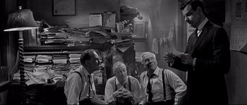 Movie still from “The Fortune Cookie” (1966), directed by Billy Wilder – A group of men sitting next to each other in a room; Medium shot, Low angle