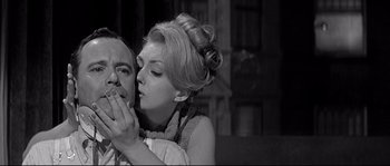 Movie still from “The Fortune Cookie” (1966), directed by Billy Wilder – An old photo of a man and a woman kissing; Close Up shot, Low angle