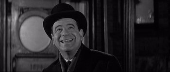 Movie still from “The Fortune Cookie” (1966), directed by Billy Wilder – An older man wearing a hat and a tie; Close Up shot, Over the shoulder angle