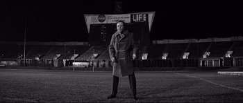 Movie still from “The Fortune Cookie” (1966), directed by Billy Wilder – A man standing in the middle of an empty field; Wide shot, Low angle