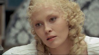 Movie still from “The Four Musketeers: Milady's Revenge” (1974), directed by Richard Lester – A person with long blonde curly hair; Close Up shot, Overhead angle