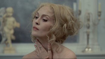 Movie still from “The Four Musketeers: Milady's Revenge” (1974), directed by Richard Lester – A beautiful woman with blonde curly hair; Close Up shot, Over the shoulder angle