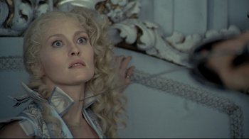 Movie still from “The Four Musketeers: Milady's Revenge” (1974), directed by Richard Lester – A person with curly blonde hair; Close Up shot, Overhead angle