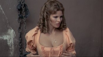 Movie still from “The Four Musketeers: Milady's Revenge” (1974), directed by Richard Lester – A woman in an old - fashioned dress is posing for a picture; Close Up shot, High angle