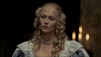 Movie still from “The Four Musketeers: Milady's Revenge” (1974), directed by Richard Lester – A woman with long blonde curly hair wearing a white dress; Close Up shot, Over the shoulder angle