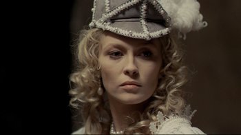 Movie still from “The Four Musketeers: Milady's Revenge” (1974), directed by Richard Lester – A woman wearing a hat and a white dress; Close Up shot, Over the shoulder angle